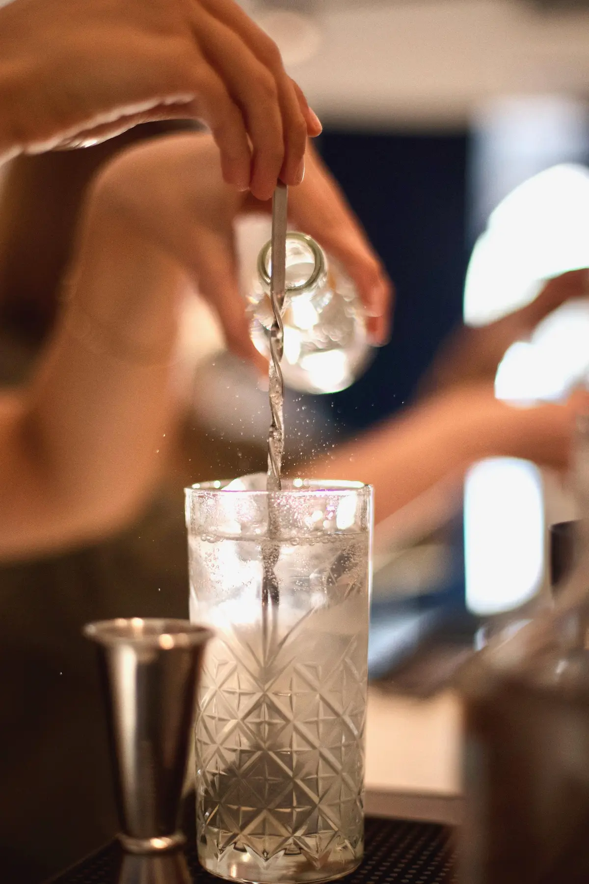 Stirring cocktail in crystal mixing glass